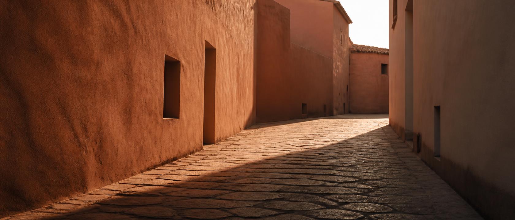 Empty cobblestone alleyway in golden-hour light